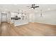 Spacious living room and kitchen combo with hardwood floors and stylish lighting fixtures at 4667 Larkfield Way, Powder Springs, GA 30127