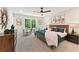 Cozy bedroom with neutral palette, accent pillows, ceiling fan and a sunny window overlooking trees at 4667 Larkfield Way, Powder Springs, GA 30127