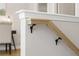 Close-up on staircase railing showing wooden trim and black brackets for a modern and secure design at 4667 Larkfield Way, Powder Springs, GA 30127