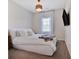 Comfortable bedroom features a bed, soft carpet and a window with shutter-style blinds at 5335 Briarstone Ridge Way, Alpharetta, GA 30022