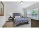 Bright bedroom with large windows, neutral walls and a comfortable queen bed at 5335 Briarstone Ridge Way, Alpharetta, GA 30022