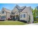 Beautiful brick house with well-maintained lawn, mature trees, and architectural details at 5335 Briarstone Ridge Way, Alpharetta, GA 30022
