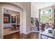 Bright foyer showcasing hardwood floors, a staircase, and an office with custom built-ins at 5335 Briarstone Ridge Way, Alpharetta, GA 30022