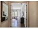 Elegant hallway view featuring dark hardwood floors and a glimpse into a well-lit, tastefully decorated bedroom at 5335 Briarstone Ridge Way, Alpharetta, GA 30022