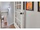 Hallway with beautiful French doors, neutral wall color and decorative sconces at 5335 Briarstone Ridge Way, Alpharetta, GA 30022