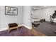 Passage to a home gym with rubber flooring, large mirror and exercise equipment at 5335 Briarstone Ridge Way, Alpharetta, GA 30022