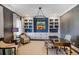 Stylish home office with custom built-in shelving, designer wallpaper, and comfortable seating at 5335 Briarstone Ridge Way, Alpharetta, GA 30022