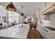 Open kitchen with a large center island and premium appliances flowing into a living area at 5335 Briarstone Ridge Way, Alpharetta, GA 30022