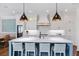 Bright, open kitchen with a large island, pendant lights, and an adjacent dining area at 5335 Briarstone Ridge Way, Alpharetta, GA 30022