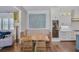 Elegant dining area connected to a kitchen with a wine fridge and custom cabinetry at 5335 Briarstone Ridge Way, Alpharetta, GA 30022