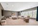 Bright living room with plush seating, large windows with plantation shutters, and stylish decor at 5335 Briarstone Ridge Way, Alpharetta, GA 30022