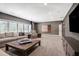 Spacious living room with cozy seating, natural light from big windows, and entertainment center at 5335 Briarstone Ridge Way, Alpharetta, GA 30022