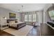 Spacious main bedroom with hardwood floors, a large window with plantation shutters, and stylish lighting at 5335 Briarstone Ridge Way, Alpharetta, GA 30022