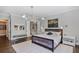 Bright main bedroom showcases a stylish bed, modern lighting, and an ensuite bathroom for added convenience at 5335 Briarstone Ridge Way, Alpharetta, GA 30022