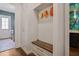 Practical mudroom with built-in storage, seating, and access to laundry and powder room at 5335 Briarstone Ridge Way, Alpharetta, GA 30022