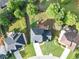Overhead view of home with lush landscaping, a spacious backyard, and a patio, surrounded by mature trees at 566 Vintage Pointe Run, Mableton, GA 30126