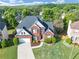 Beautiful aerial view of the home with a well-manicured lawn, lush landscaping, and a welcoming facade at 566 Vintage Pointe Run, Mableton, GA 30126