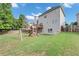 Expansive backyard with a playset, deck and green lawn, ideal for outdoor entertaining and Gathering enjoyment at 566 Vintage Pointe Run, Mableton, GA 30126