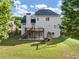 Backyard featuring a large lawn and a wooden deck with stairs, perfect for outdoor enjoyment at 566 Vintage Pointe Run, Mableton, GA 30126