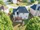 Aerial view of backyard featuring a spacious wooden deck, lush lawn, and ' playset at 566 Vintage Pointe Run, Mableton, GA 30126