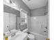 Bathroom with a single sink, toilet, window, and a tub with shower at 566 Vintage Pointe Run, Mableton, GA 30126