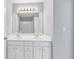 Bathroom with a double vanity, mirrors, and view of tub with shower in background at 566 Vintage Pointe Run, Mableton, GA 30126
