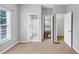 Bedroom featuring neutral walls and carpet, leading to a bathroom and a closet at 566 Vintage Pointe Run, Mableton, GA 30126