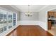 Elegant dining room featuring hardwood floors, chandelier, and a view of the kitchen at 566 Vintage Pointe Run, Mableton, GA 30126