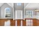 Bright foyer with high ceilings, hardwood floors, large windows, and a view into adjacent rooms at 566 Vintage Pointe Run, Mableton, GA 30126