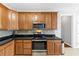 A kitchen featuring wood cabinets, tile backsplash, and stainless steel appliances at 566 Vintage Pointe Run, Mableton, GA 30126