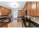 Spacious kitchen equipped with granite counters, stainless appliances, and wood cabinets at 566 Vintage Pointe Run, Mableton, GA 30126