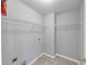 Functional laundry room with practical shelving and easy-to-clean tile flooring at 566 Vintage Pointe Run, Mableton, GA 30126