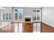 Well-lit living room with fireplace, hardwood floors, and French doors to the deck at 566 Vintage Pointe Run, Mableton, GA 30126