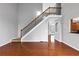 Open-concept living room showcasing hardwood flooring, staircase, and neutral paint at 566 Vintage Pointe Run, Mableton, GA 30126