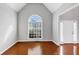 Bright living room with large window, hardwood floors and neutral paint scheme at 566 Vintage Pointe Run, Mableton, GA 30126