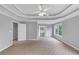 Expansive primary bedroom featuring trey ceiling, neutral carpet, and inviting doorways at 566 Vintage Pointe Run, Mableton, GA 30126