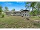 A white brick home featuring a large backyard and a fire pit at 1520 Oxford St, Douglasville, GA 30134