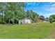 Expansive backyard featuring lush green grass and mature trees, perfect for outdoor activities at 1520 Oxford St, Douglasville, GA 30134