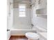 Bright bathroom featuring white tiled walls and a bathtub with shower at 1520 Oxford St, Douglasville, GA 30134