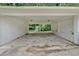 Carport featuring painted white brick walls and concrete floors at 1520 Oxford St, Douglasville, GA 30134