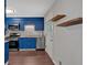 Modern kitchen features blue cabinets, stainless steel appliances, and open shelving at 1520 Oxford St, Douglasville, GA 30134