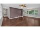 Open living room featuring hardwood floors, a modern ceiling fan, and a view into the kitchen at 1520 Oxford St, Douglasville, GA 30134