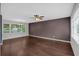 Spacious living room with hardwood floors, large windows, and modern ceiling fan at 1520 Oxford St, Douglasville, GA 30134