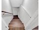 View of the stairwell with wood steps and white painted walls at 1520 Oxford St, Douglasville, GA 30134