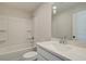 Bright bathroom featuring a shower-tub combo and a modern sink with white countertop at 4529 Twinberry Dr, Powder Springs, GA 30127