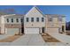 Charming townhome features a brick and white facade with a paved driveway and attached garages at 4529 Twinberry Dr, Powder Springs, GA 30127