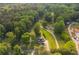 Stunning aerial view of a home nestled among lush trees, showcasing its expansive property and serene location at 780 Old Magnolia Trl, Canton, GA 30115