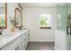 Bright bathroom features dual sinks, granite countertops, modern fixtures, and a glass shower at 780 Old Magnolia Trl, Canton, GA 30115