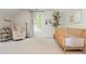 Bright Bedroom features a rocker, decorative tree, and modern crib at 780 Old Magnolia Trl, Canton, GA 30115