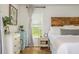 Bright bedroom showcasing wood floors, decorative furniture, and a wood accent headboard at 780 Old Magnolia Trl, Canton, GA 30115